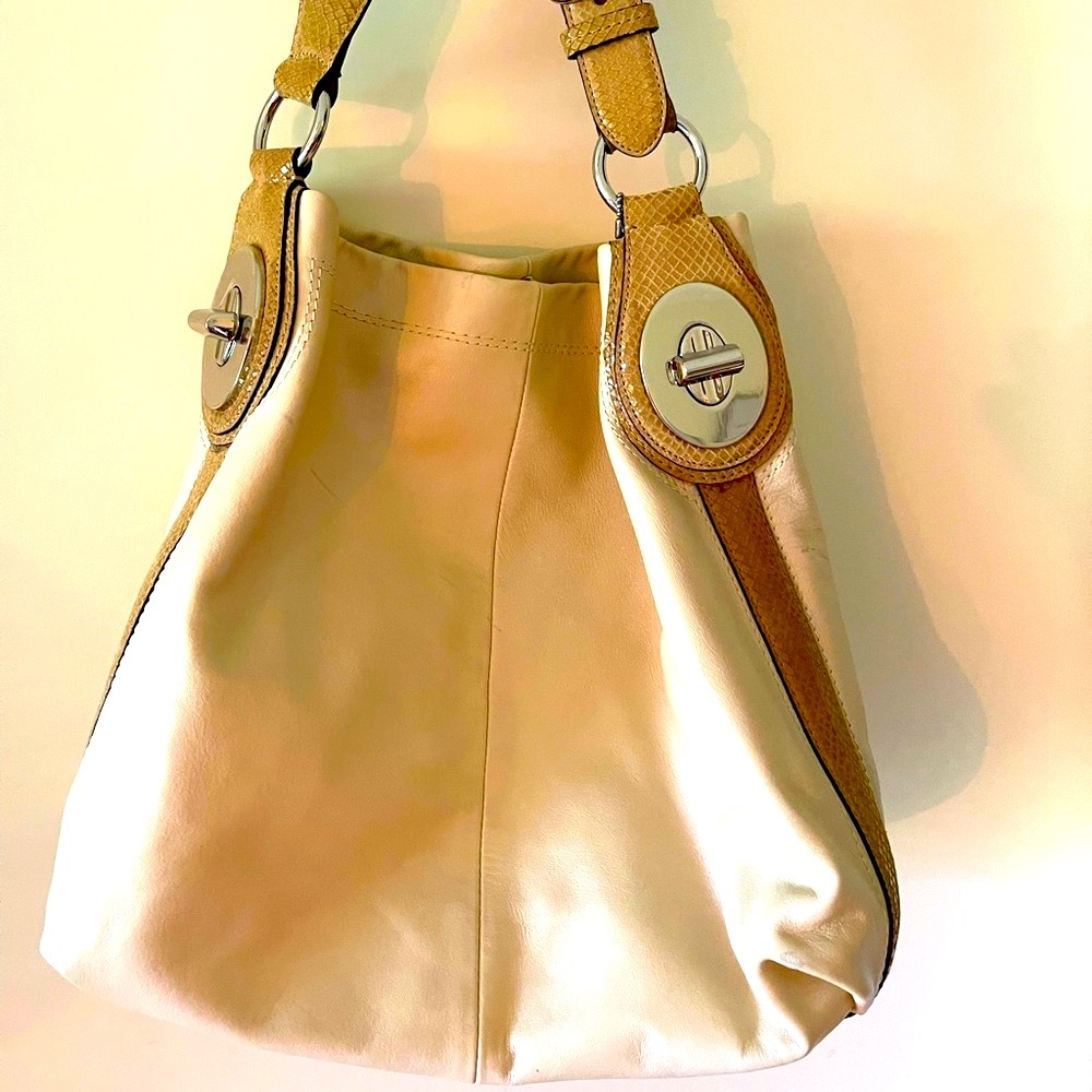 Coach neutral colored supple leather.